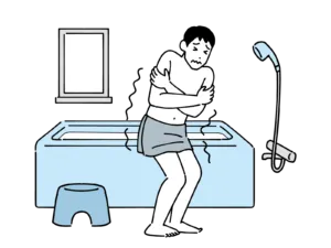 寒い浴室で震える男性